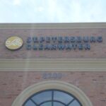 Channel letters spelling St. Petersburg Clearwater mounted on a brick building facade